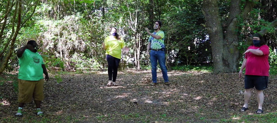 Four people standing in the woods image