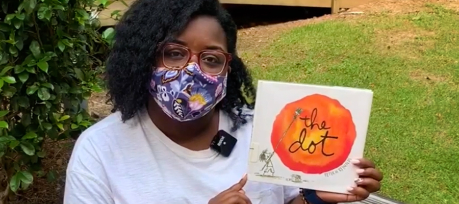 woman wearing mask reading