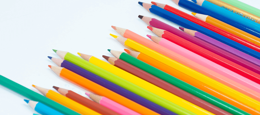 colored pencils lined up on white background