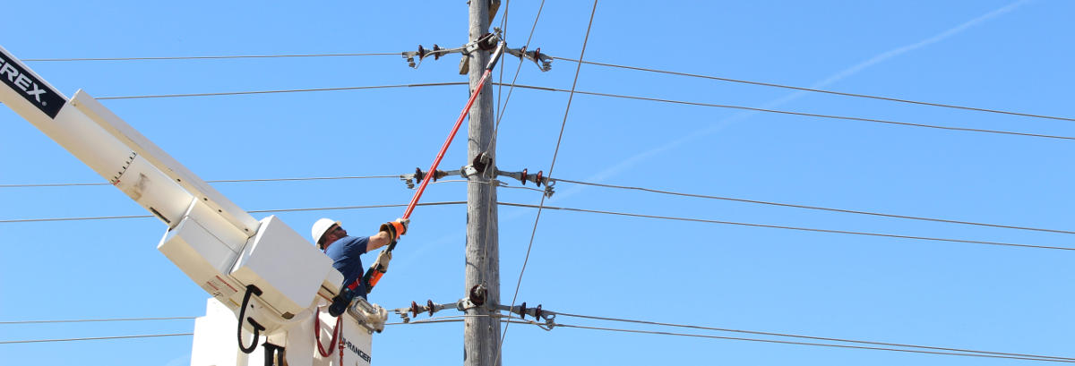 Man fixing power lines at the top