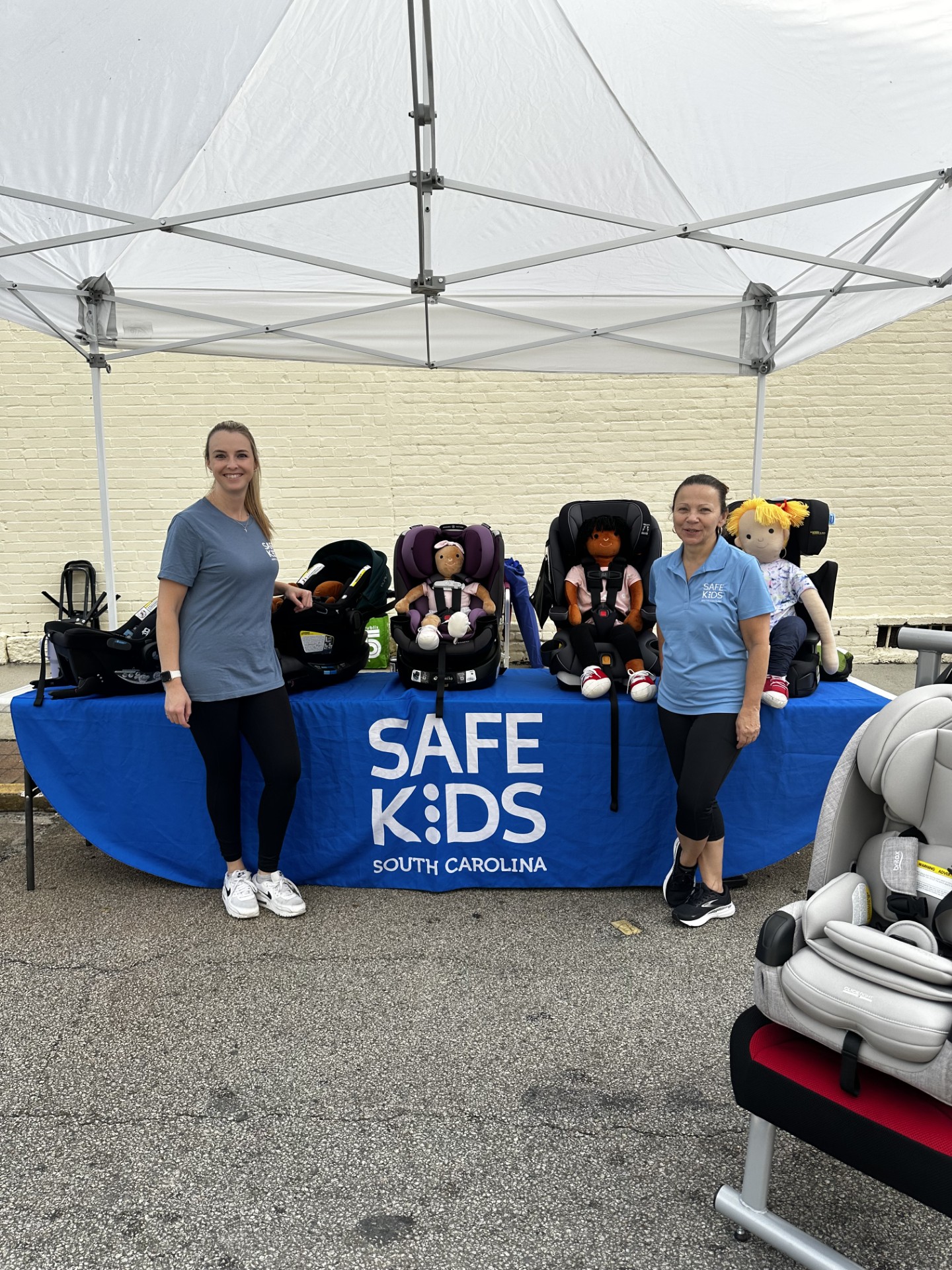 Safe Kids SC volunteers and table with car seats