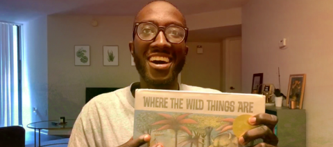 adult man reading where the wild things are