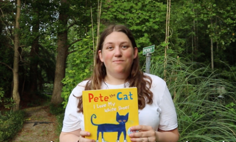 woman holding pete the cat book
