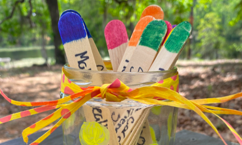 decorated popsicle sticks in jar