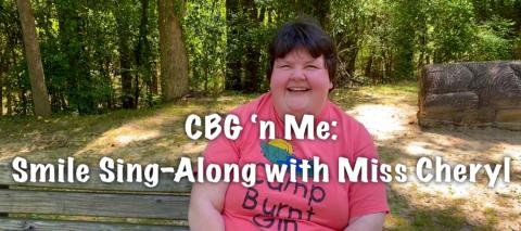 Person sitting on a picnic bench in nature with "CBG 'n Me: Smile Sing-Along with Miss Cheryl" wording