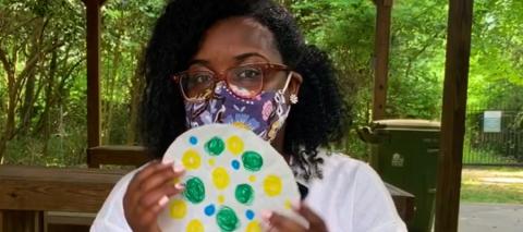 woman wearing mask making dot art